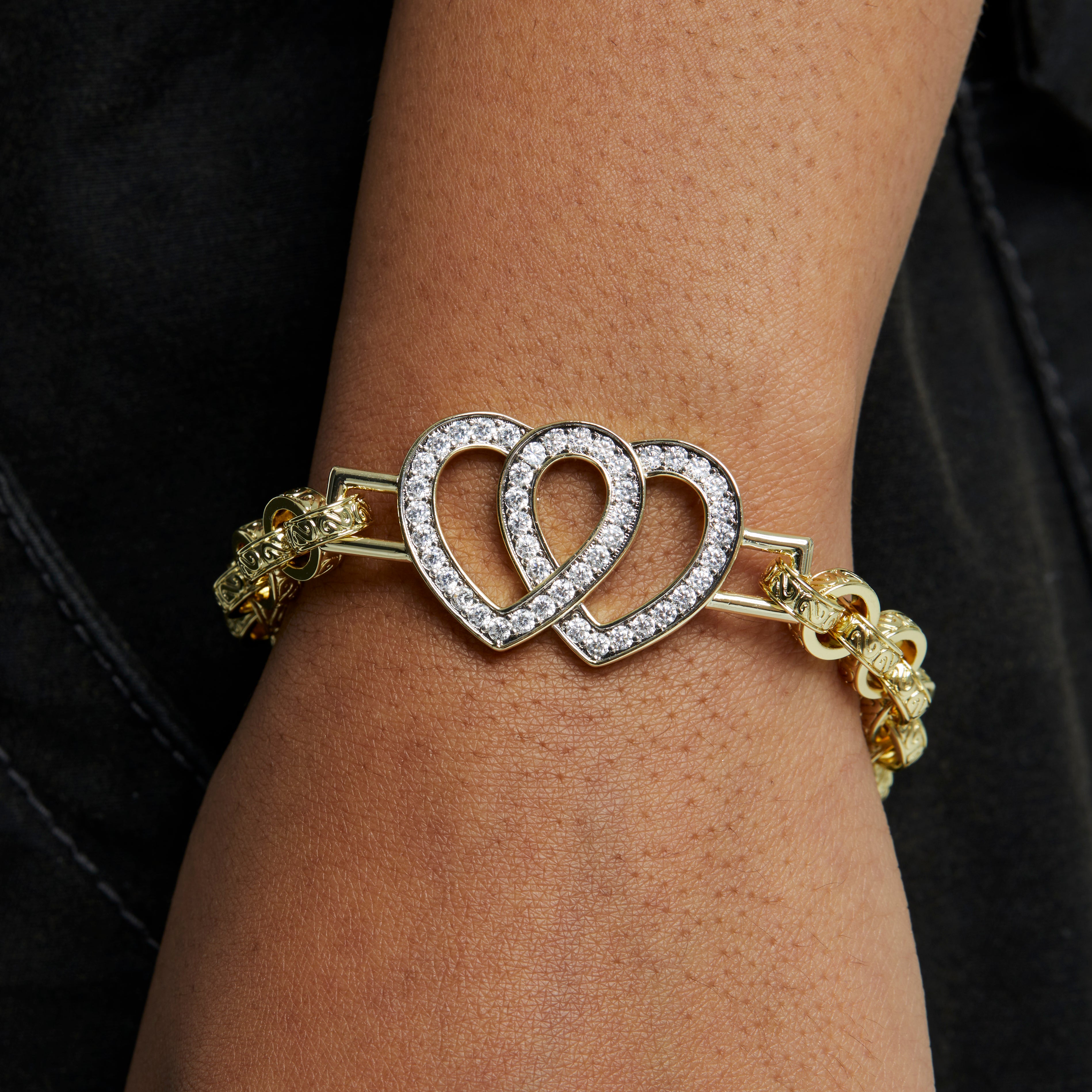 A gold-toned diamond double heart belcher bracelet featuring a belcher chain and a double heart charm adorned with sparkling diamonds.